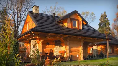 a log cabin with a black roof at Chata w Rabce - Bajkowa Osada in Rabka