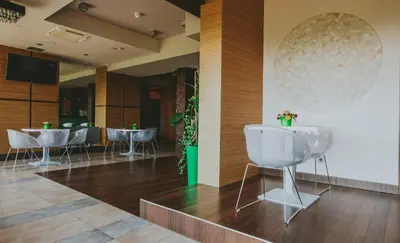 a woman sitting in front of a hot tub at Hotel Radocza Park Business & Spa in Radocza
