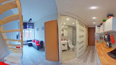 a room with a staircase and a living room at Apartamenty Marco - Stare Miasto - Super Wi Fi in Kraków
