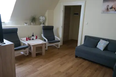 a living room with two blue chairs and a table at Apartamenty Marco - Stare Miasto - Super Wi Fi in Kraków