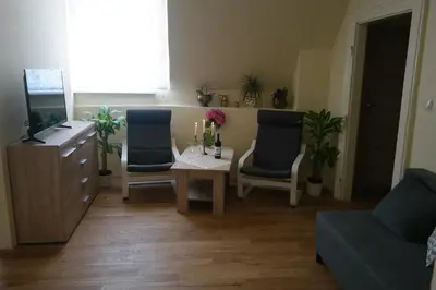 a living room with a table and two chairs and a television at Apartamenty Marco - Stare Miasto - Super Wi Fi in Kraków