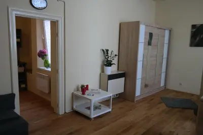 a living room with a table and a mirror at Apartamenty Marco - Stare Miasto - Super Wi Fi in Kraków