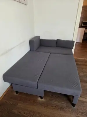 a bed in the corner of a room at Apartamenty Marco - Stare Miasto - Super Wi Fi in Kraków