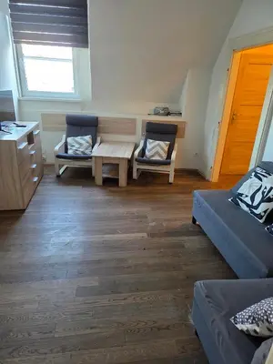 a living room with two chairs and a table at Apartamenty Marco - Stare Miasto - Super Wi Fi in Kraków