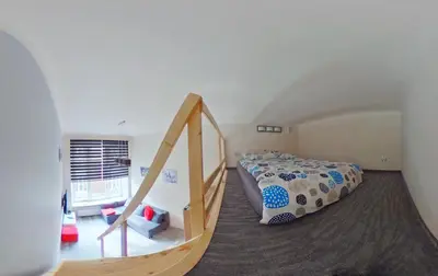 a bedroom with a bed and a staircase in a room at Apartamenty Marco - Stare Miasto - Super Wi Fi in Kraków