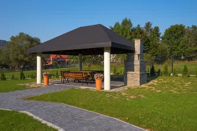 an empty restaurant with green tables and chairs at Beskid in Zawoja