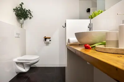 a bathroom with a sink and a toilet at Kurkowa Apartments in Kraków