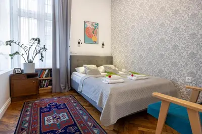 a bedroom with a bed with towels on it at Kurkowa Apartments in Kraków