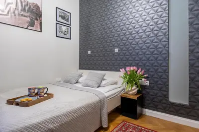 a bedroom with a bed with a tray on it at Kurkowa Apartments in Kraków