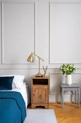 a bedroom with a bed and a table with a lamp at Sleeping in Krakow Main Market in Kraków