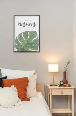 a bedroom with a bed with a plant picture on the wall at Sleeping in Krakow Main Market in Kraków
