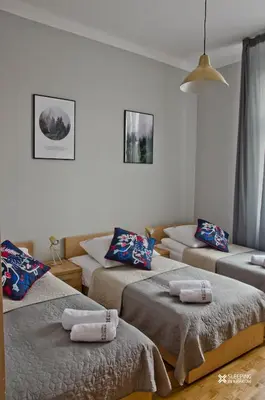 a room with three beds with pillows on them at Sleeping in Krakow Main Market in Kraków