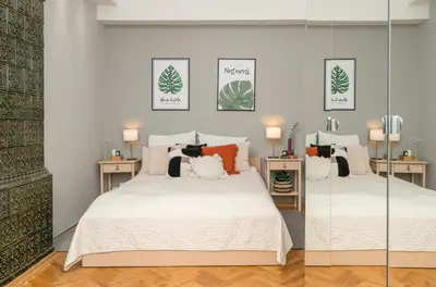 a bedroom with two beds and two mirrors at Sleeping in Krakow Main Market in Kraków