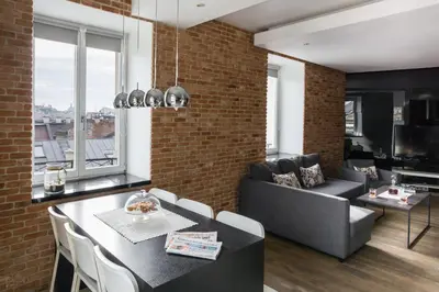 a living room with a couch and a table at Yourplace Biskupia Old Town Apartments in Kraków