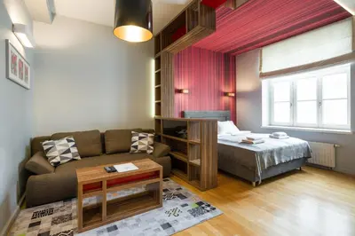 a living room with a couch and a bed at Yourplace Biskupia Old Town Apartments in Kraków