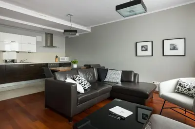 a living room with a couch and a table at Yourplace Biskupia Old Town Apartments in Kraków