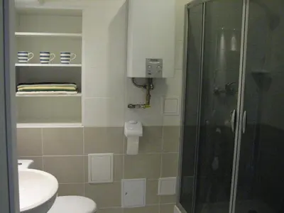 a bathroom with a shower and a toilet and a sink at Salwator Apartments in Kraków
