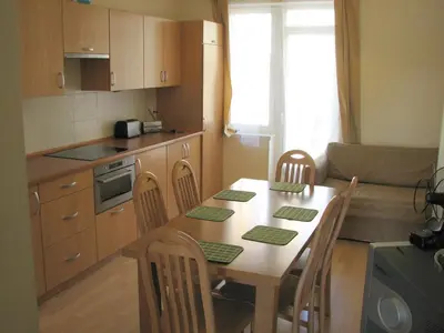 a kitchen with a table and chairs in a kitchen at Salwator Apartments in Kraków