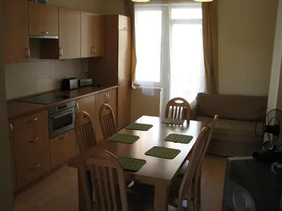 a kitchen with a table and chairs and a kitchen with a table and a kitchen at Salwator Apartments in Kraków