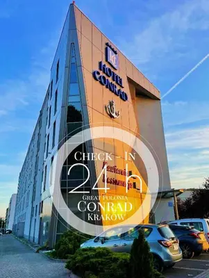 a building with a sign on the side of it at Hotel Great Polonia Conrad Kraków in Kraków