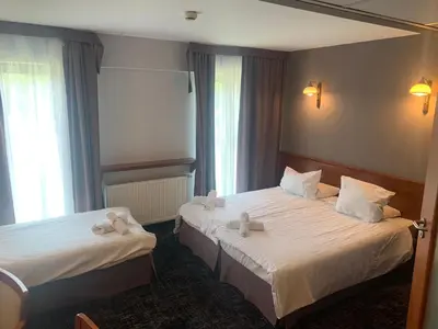 two beds in a hotel room with towels on them at Hotel Great Polonia Conrad Kraków in Kraków