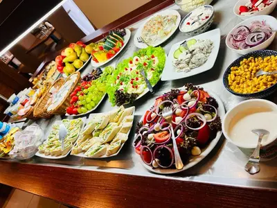 a buffet of different types of food on a table at Hotel Great Polonia Conrad Kraków in Kraków