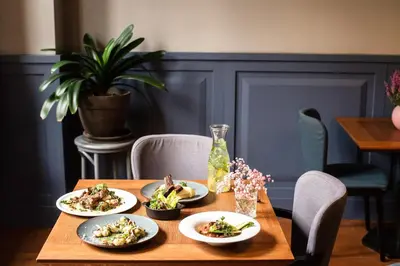 a wooden table with plates of food on it at Residence 9 in Kraków