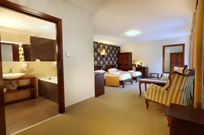 a hotel room with a bathroom and a bedroom at Residence 9 in Kraków
