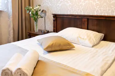 a bed with two towels and two pillows on it at Residence 9 in Kraków