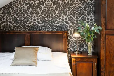 a bedroom with a bed and a table with a vase of flowers at Residence 9 in Kraków
