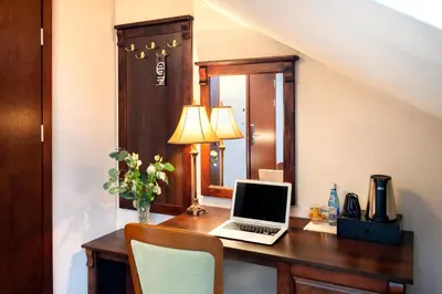 a desk with a laptop computer on it in a room at Residence 9 in Kraków