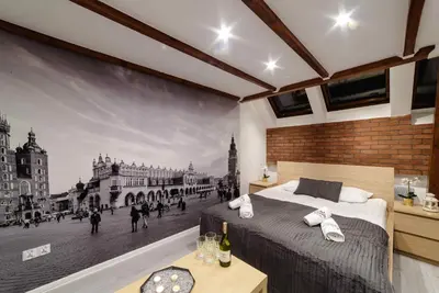 a bedroom with a wall mural of a city at Cracow Rent Apartments - spacious apartments for 2-7 people in quiet area - Kolberga Street nr 3 - 10 min to Main Square by foot in Kraków