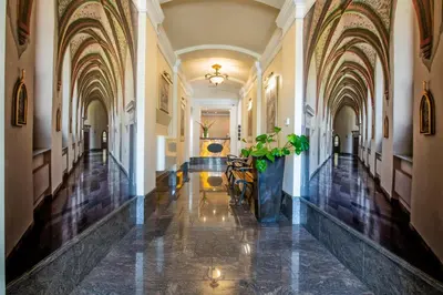 a hallway of a building with a potted plant at Aparthotel Globus Self-Check in in Kraków