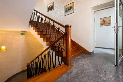 a spiral staircase in a house with a glass door at Aparthotel Globus Self-Check in in Kraków