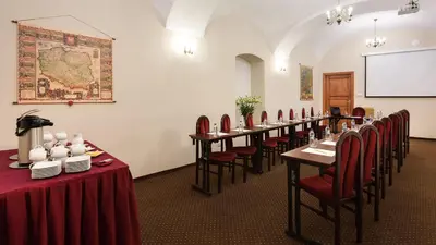 a bedroom with a bed with a lamp and candles at Hotel Wit Stwosz in Kraków