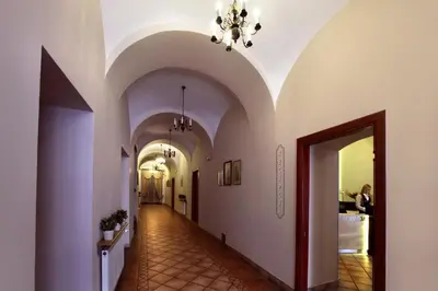 a long row of tables in a room with red chairs at Hotel Wit Stwosz in Kraków