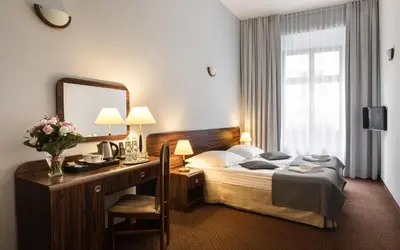 a dining room with a table and chairs at Hotel Wit Stwosz in Kraków