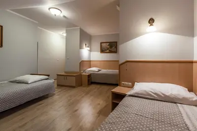 a room with two beds and two lights on the wall at Antica Residence in Kraków