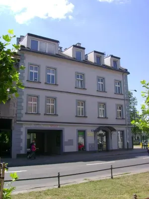 a large white building on the side of a street at Antica Residence in Kraków