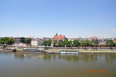 a river with boats docked in a city at apartament studio solna 1 M19 in Kraków