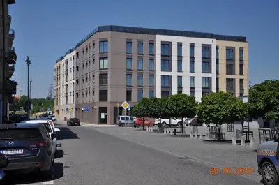 a large building with cars parked in a parking lot at apartament studio solna 1 M19 in Kraków