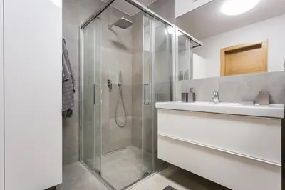 a bathroom with a glass shower and a sink at apartament studio solna 1 M19 in Kraków