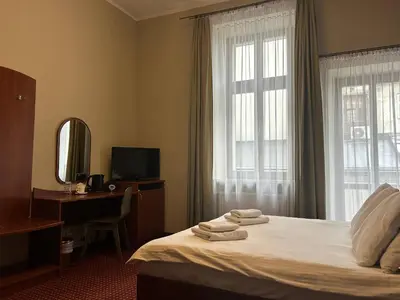 a hotel room with a bed and a chair at Aneks Hotelu Kazimierz in Kraków