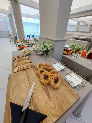 a table with pretzels and other food on it at Aneks Hotelu Kazimierz in Kraków
