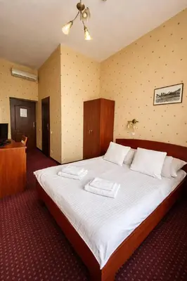 a hotel room with two beds and a window at Aneks Hotelu Kazimierz in Kraków
