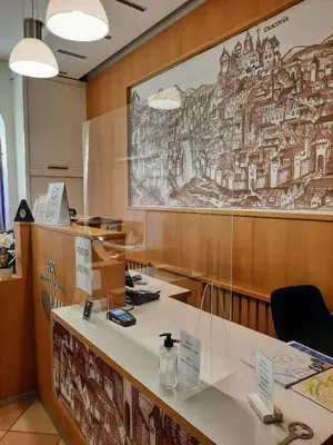 a hotel room with two beds and a desk at Aneks Hotelu Kazimierz in Kraków