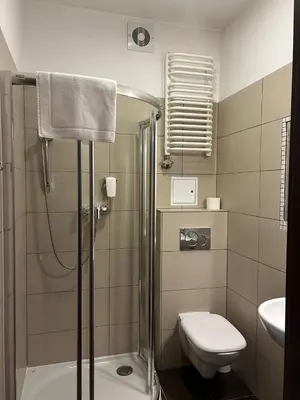 a bathroom with a sink and a shower and a toilet at Aneks Hotelu Kazimierz in Kraków