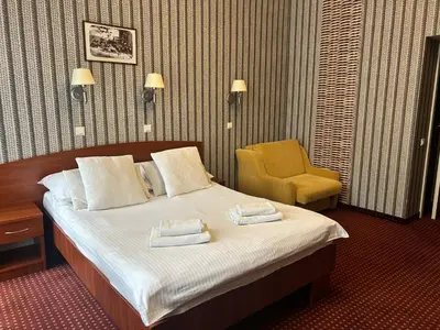 a hotel room with two beds and a desk at Aneks Hotelu Kazimierz in Kraków