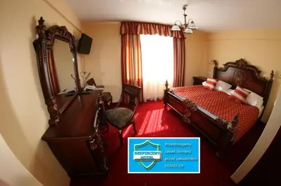 a hotel room with a bed and a mirror at Daisy Superior in Kraków