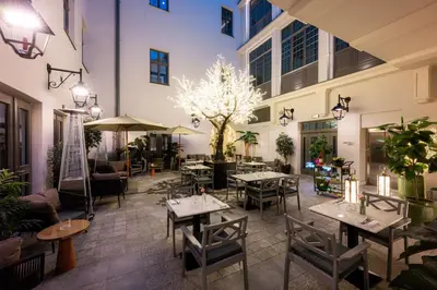 a restaurant with tables and chairs in a building at Hotel Saski Krakow Curio Collection by Hilton in Kraków